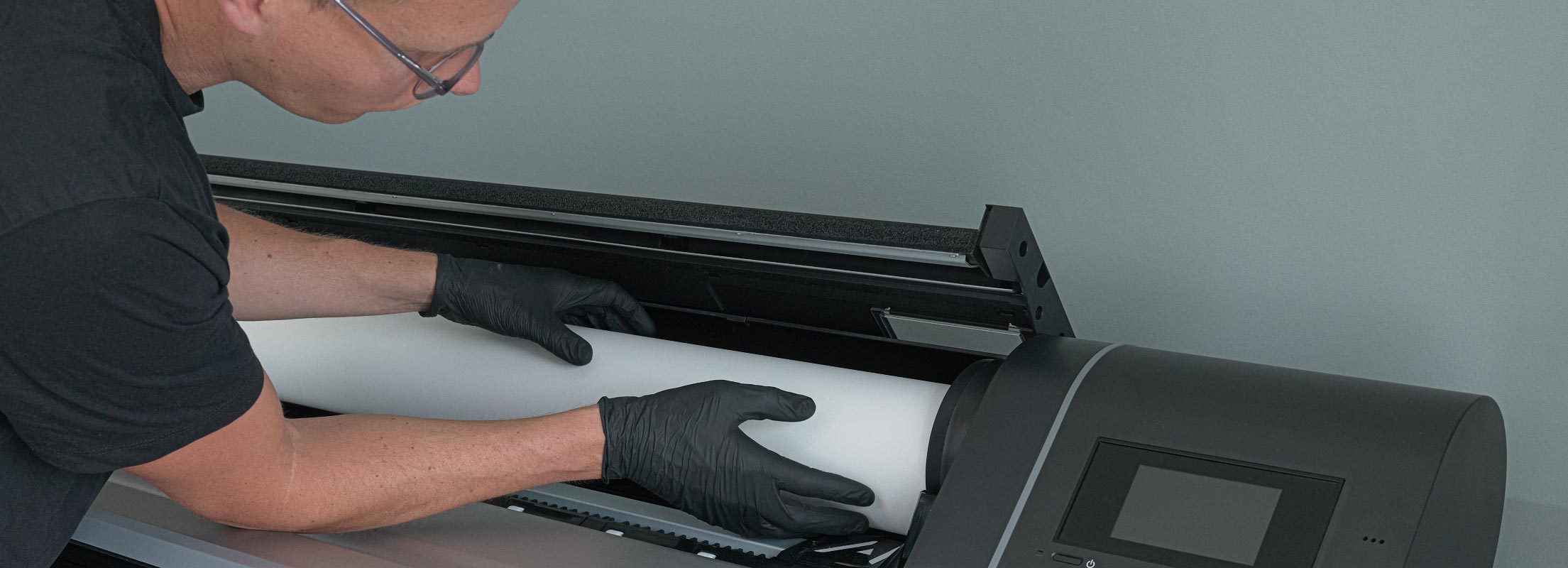 Rinus loading a roll of paper into his Epson SC-P9500 fine‑art printer in Sweden